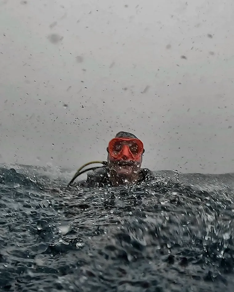 Mariya surfacing in choppy grey water