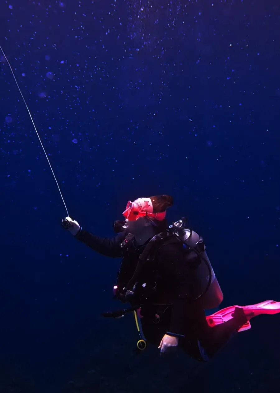 Mariya holding the descent line in deep blue water