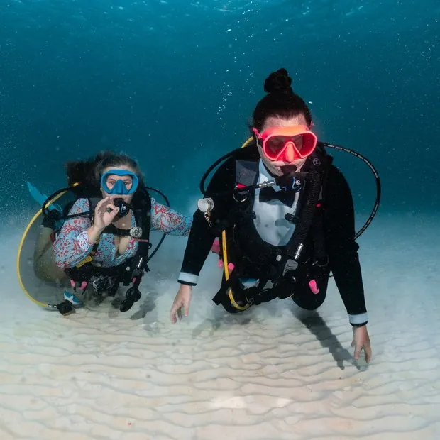 Two divers on the sand