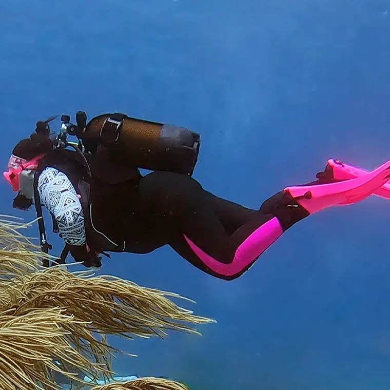 Mariya swimming over soft coral
