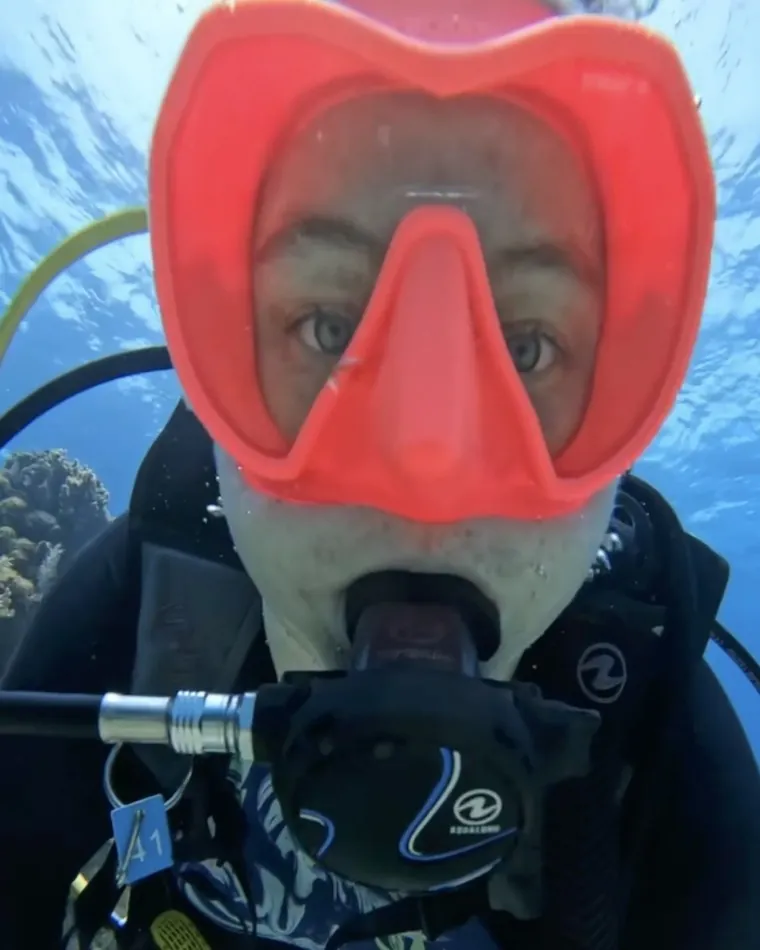 Mariya close to the camera underwater in a pink mask