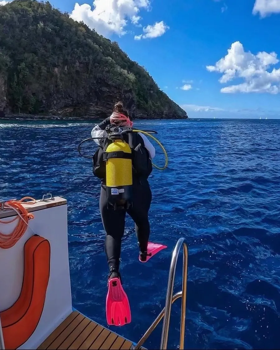 Stepping off the boat in pink fins